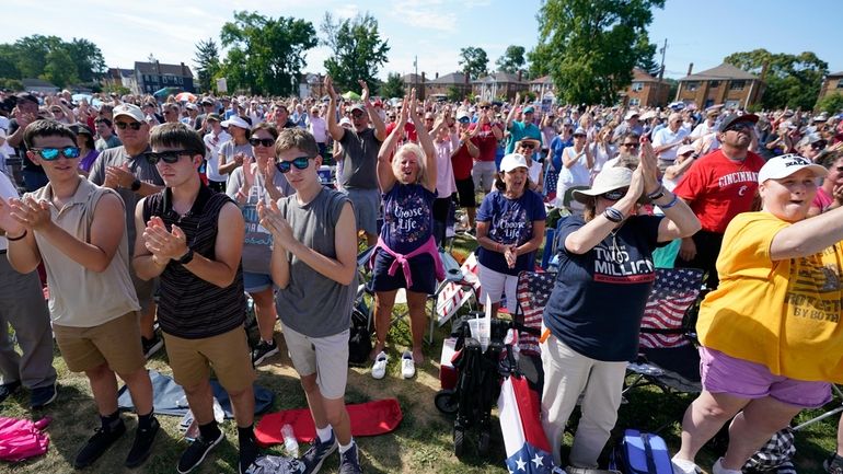 A crowd cheers as Jim Caviezel speaks during a "rosary...