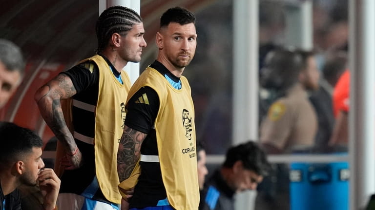 Argentina's Lionel Messi stands on the bench during a Copa...