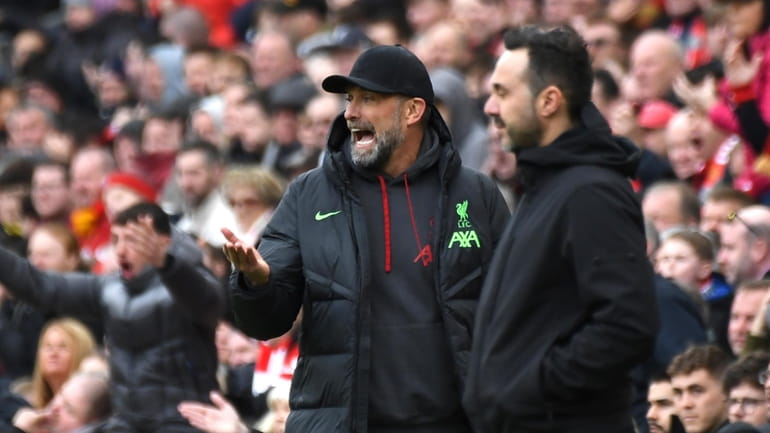 Liverpool's manager Jurgen Klopp, left, reacts during the English Premier...