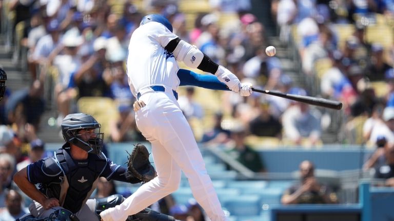 Los Angeles Dodgers designated hitter Shohei Ohtani hits a foul...