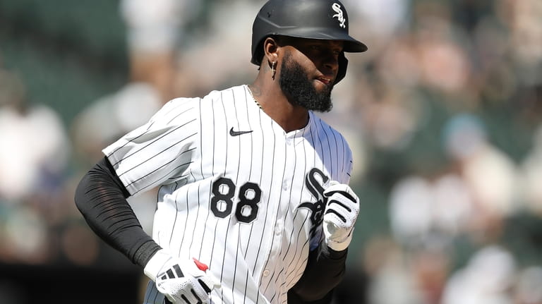 Chicago White Sox's Luis Robert Jr. looks on after hitting...