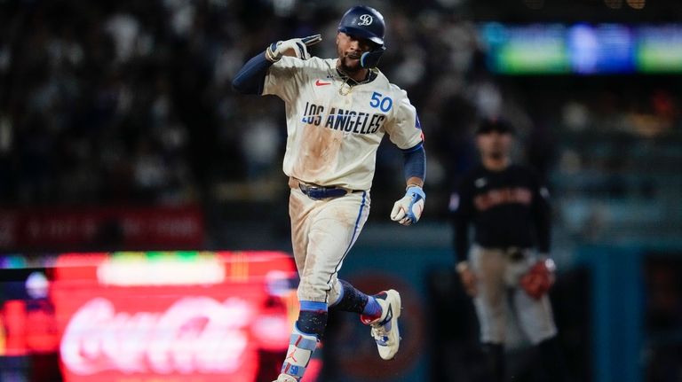 Los Angeles Dodgers' Mookie Betts celebrates after hitting a home...