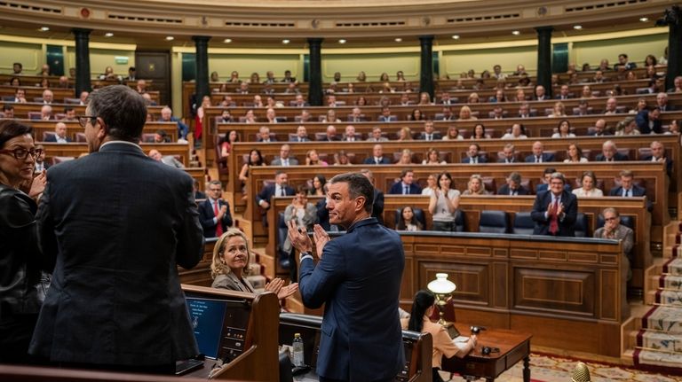 Acting Prime Minister Pedro Sanchez, center, applauds at the Spanish...