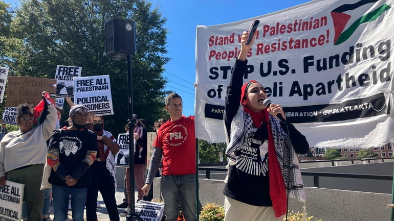 Pro-Palestinian demonstrators chant slogans outside the Israeli consulate in Atlanta...