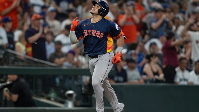 Houston Astros' Yainer Diaz celebrates while rounding the bases after...