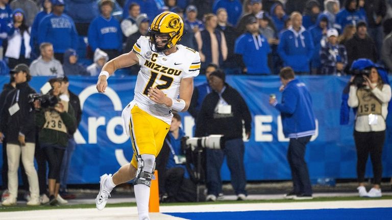 Missouri quarterback Brady Cook (12) celebrates after scoring a touchdown...