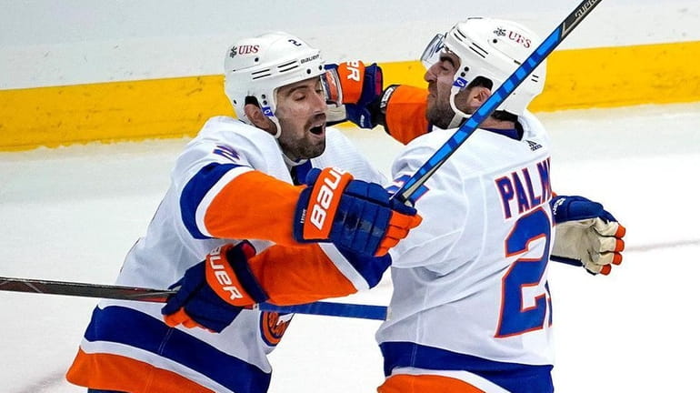 The Islanders' Kyle Palmieri, center, celebrates with Nick Leddy and...
