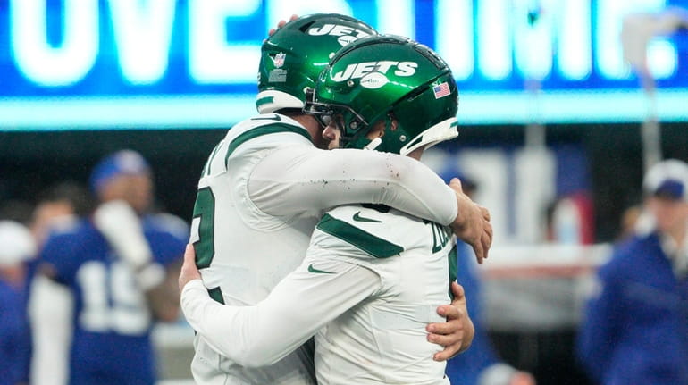 Jets kicker Greg Zuerlein celebrates with Thomas Hennessy after kicking...