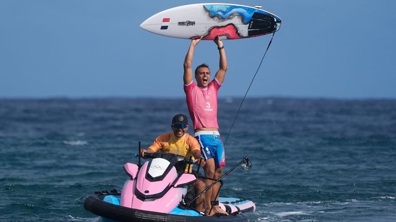 Kauli Vaast, of France, celebrates after winning the gold medal...