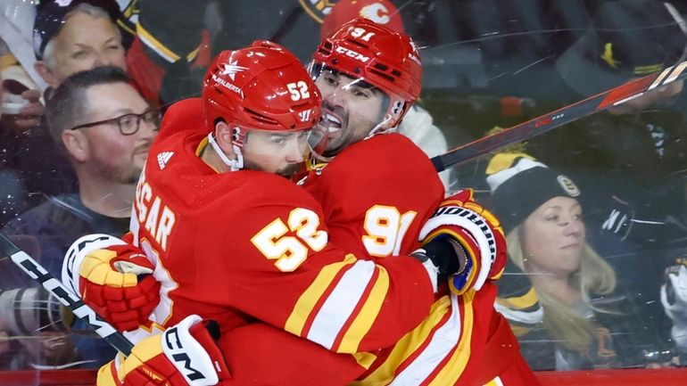 Calgary Flames' Nazem Kadri, right, celebrates his overtime goal against...