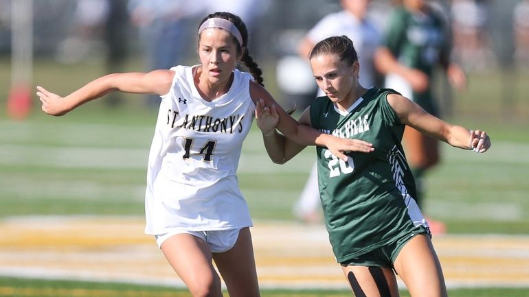 St. Anthony's Elliana Dos Santos and Ward Melville's Maddie Costello fight for...