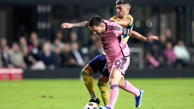 Inter Miami forward Lionel Messi, front, controls the ball as...