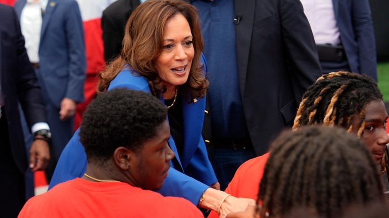 Democratic presidential nominee Vice President Kamala Harris greets members of...