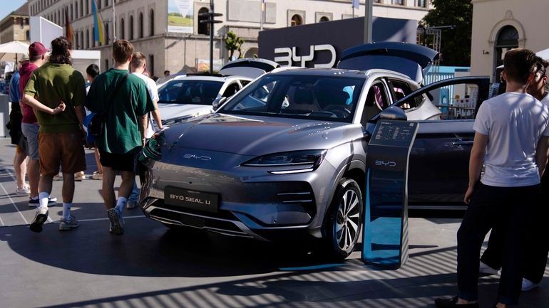 File - Visitors watch a BYD Seal U car at...