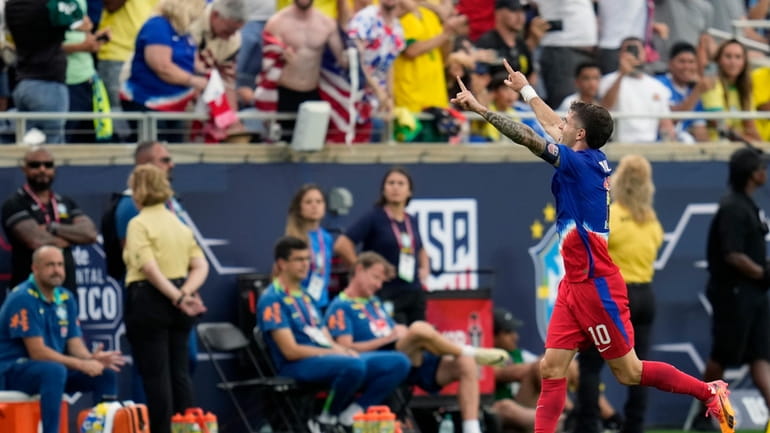 U.S. forward Christian Pulisic (10) celebrates his goal against Brazil...