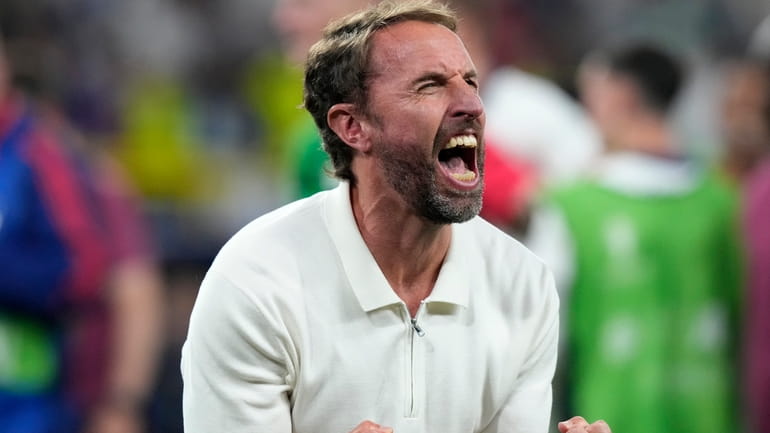 England's manager Gareth Southgate celebrates after winning a semifinal match...