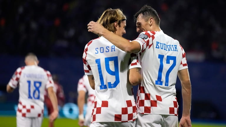 Croatia's Ante Budimir, right, celebrates with his teammate Borna Sosa...
