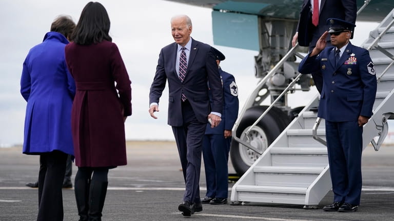 President Joe Biden walks to greet Massachusetts Gov. Maura Healey,...