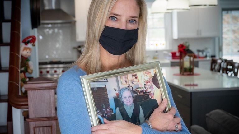 Dix Hills resident Mary Lehmann holds a photo of her...