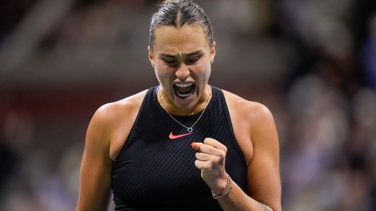 Aryna Sabalenka, of Belarus, reacts after scoring a point against...