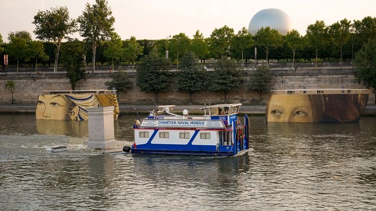 A boat sails past reproductions of artworks decorating the banks...