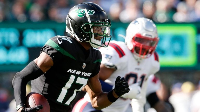 Garrett Wilson of the Jets runs the ball in the second half...