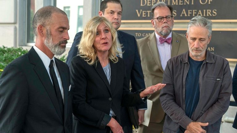 Kim Brooks, second from left, speaks during an interview outside...