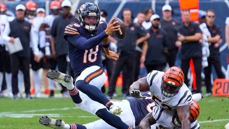 Chicago Bears quarterback Caleb Williams (18) breaks away from a...