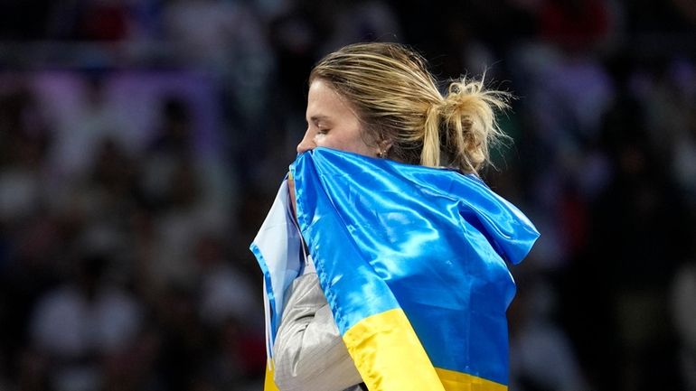 Ukraine's Olga Kharlan celebrates after winning the women's team sabre...