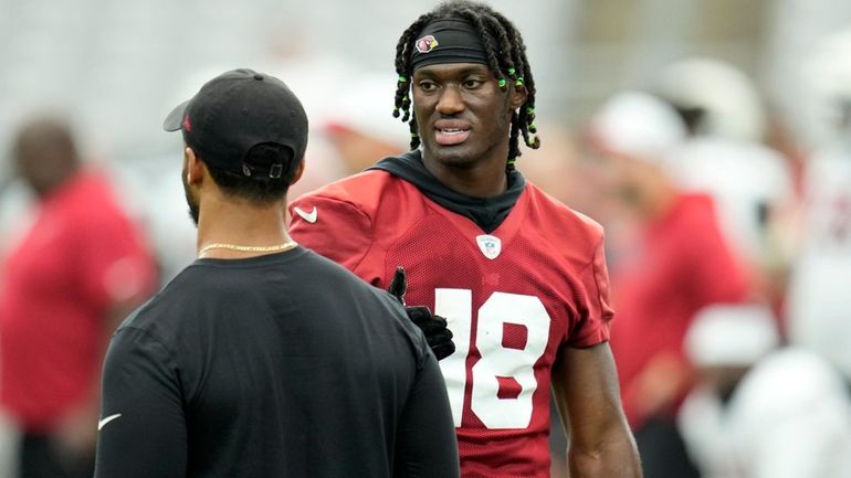 Arizona Cardinals wide receiver Marvin Harrison Jr. (18) talks with...