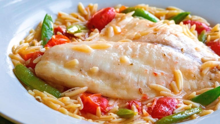 Tilapia gently poached with vegetables and orzo pasta. (August 2022)