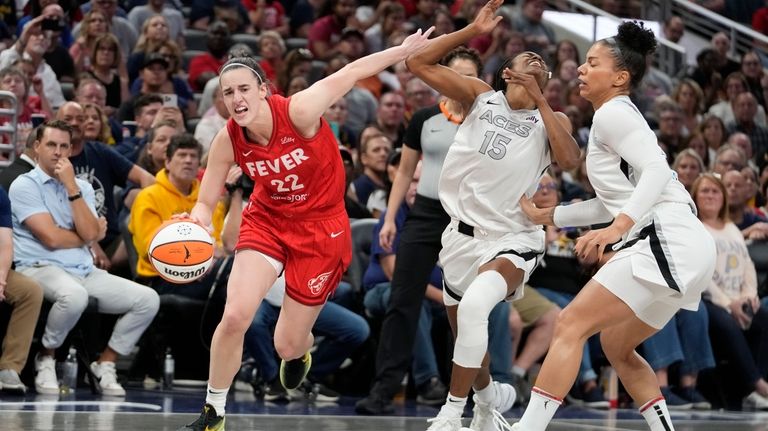 Indiana Fever's Caitlin Clark (22) is called for a foul...