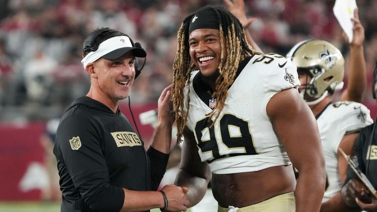 New Orleans Saints head coach Dennis Allen laughs with defensive...