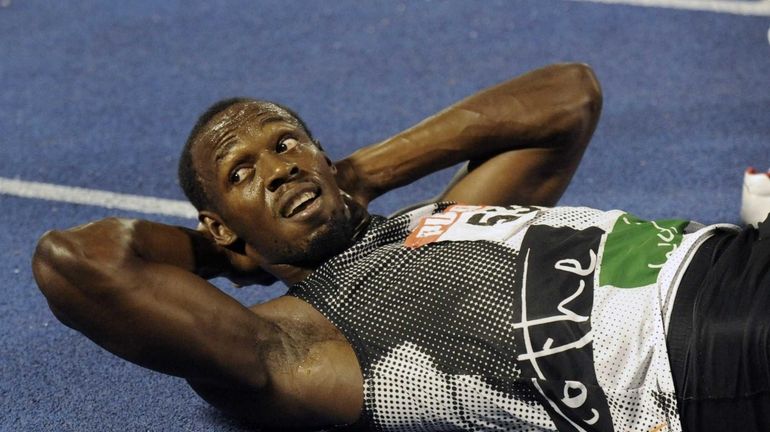 World-record holder Usain Bolt looks at the crowd while getting...