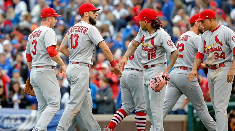 Matt Carpenter #13 of the St. Louis Cardinals high fives...