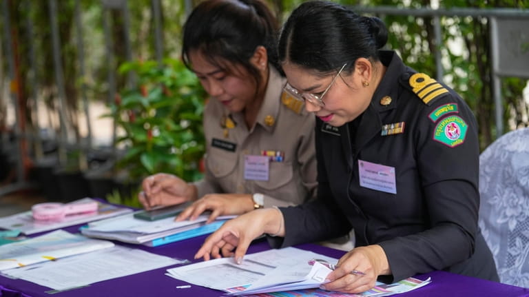 Thai officer check document from potential candidates to become members...