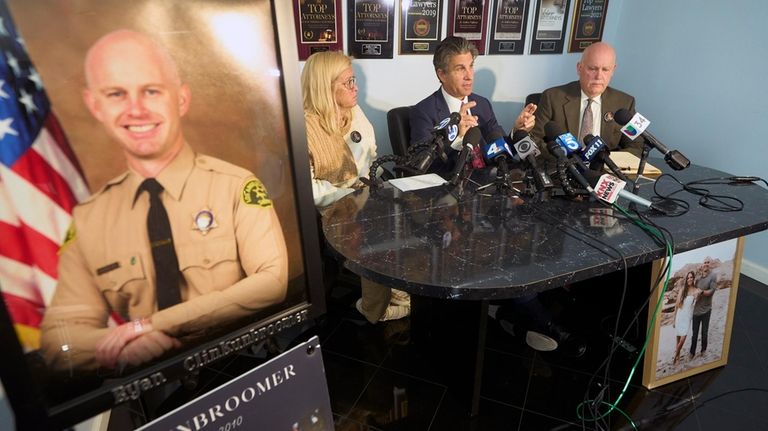 Attorney Bradley Gage, middle, and Kim Clinkunbroomer, left, and Mike...