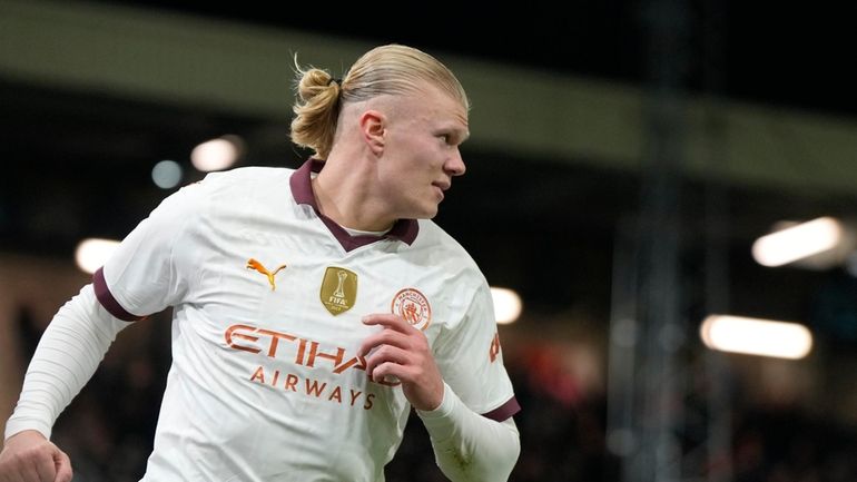 Manchester City's Erling Haaland celebrates after scoring his side's third...