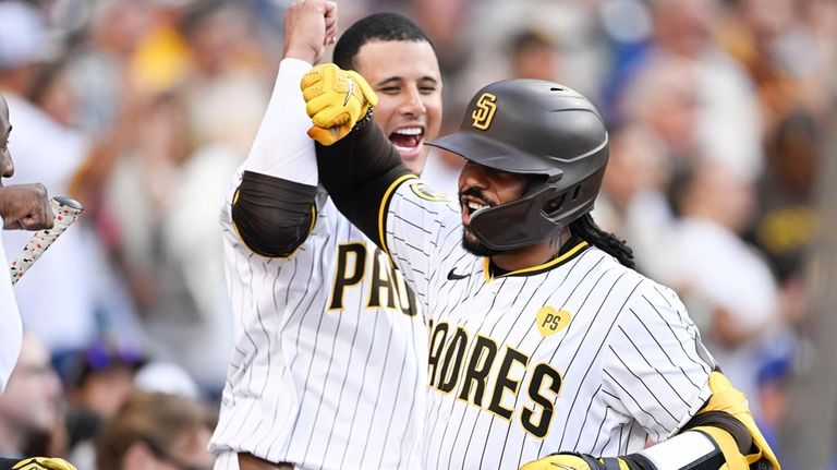 San Diego Padres catcher Luis Campusano (12), right, is congratulated...