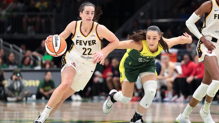Indiana Fever guard Caitlin Clark (22) drives as Seattle Storm...