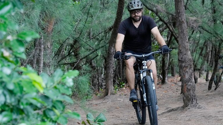 Javier Fernandez, of Hollywood, rides on a mountain bike trail...