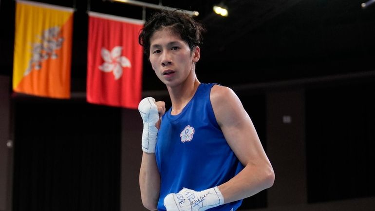 Taiwan's Lin Yu-ting poses after winning against India's Parveen in...