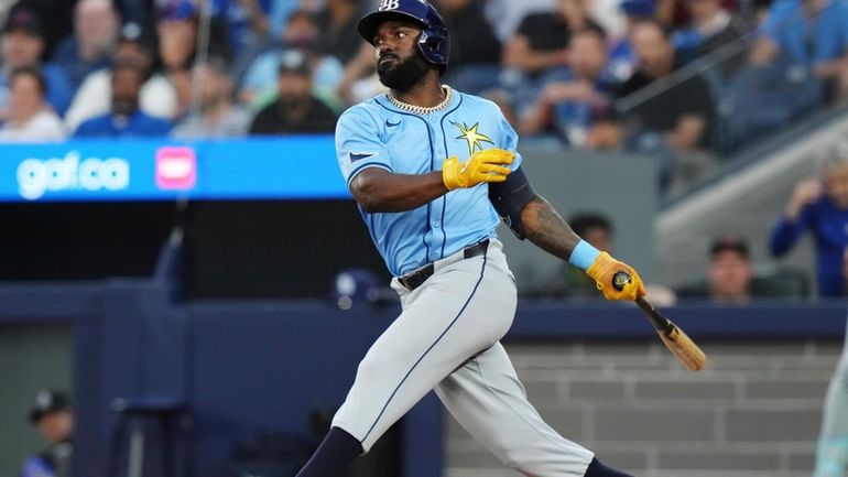 Tampa Bay Rays' Randy Arozarena (56) hits an RBI single...