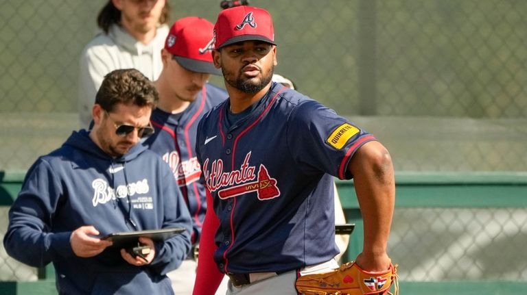 Atlanta Braves pitcher Reynaldo Lopez warms up during spring training...