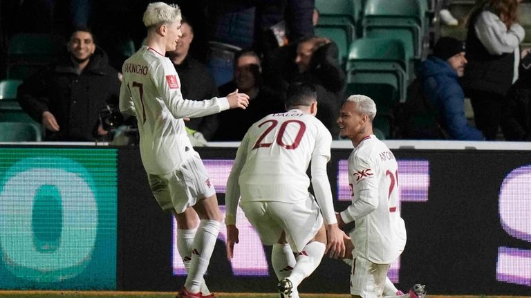 Manchester United's Antony, right, celebrates after scoring his side's third...