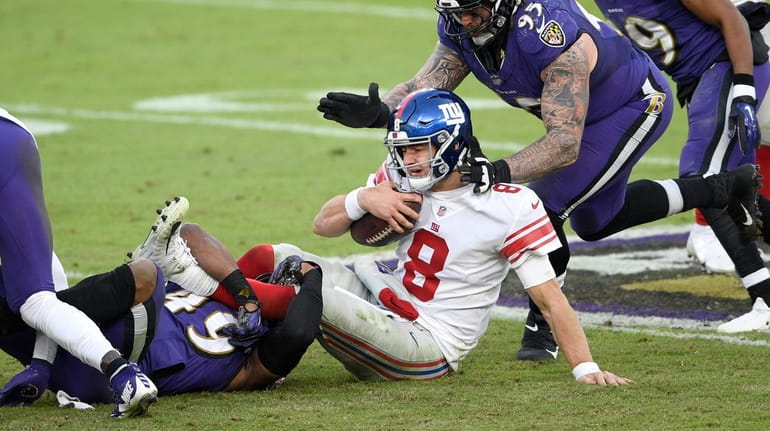Giants quarterback Daniel Jones (8) is sacked by Baltimore Ravens...