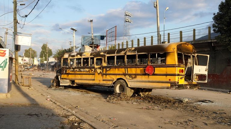 A bus set on fire by gang members at the...