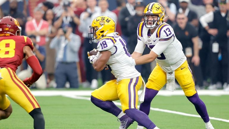 LSU quarterback Garrett Nussmeier (13) hands off to running back...