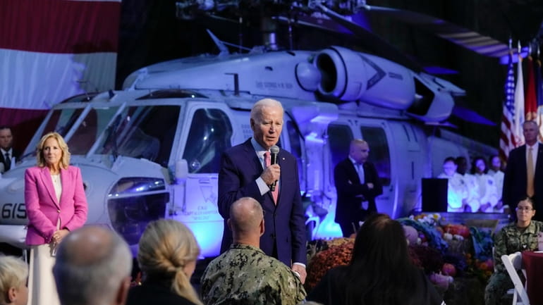 President Joe Biden speaks with service members and their relatives...