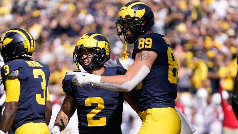 Michigan running back Blake Corum (2) celebrates his rushing touchdown...